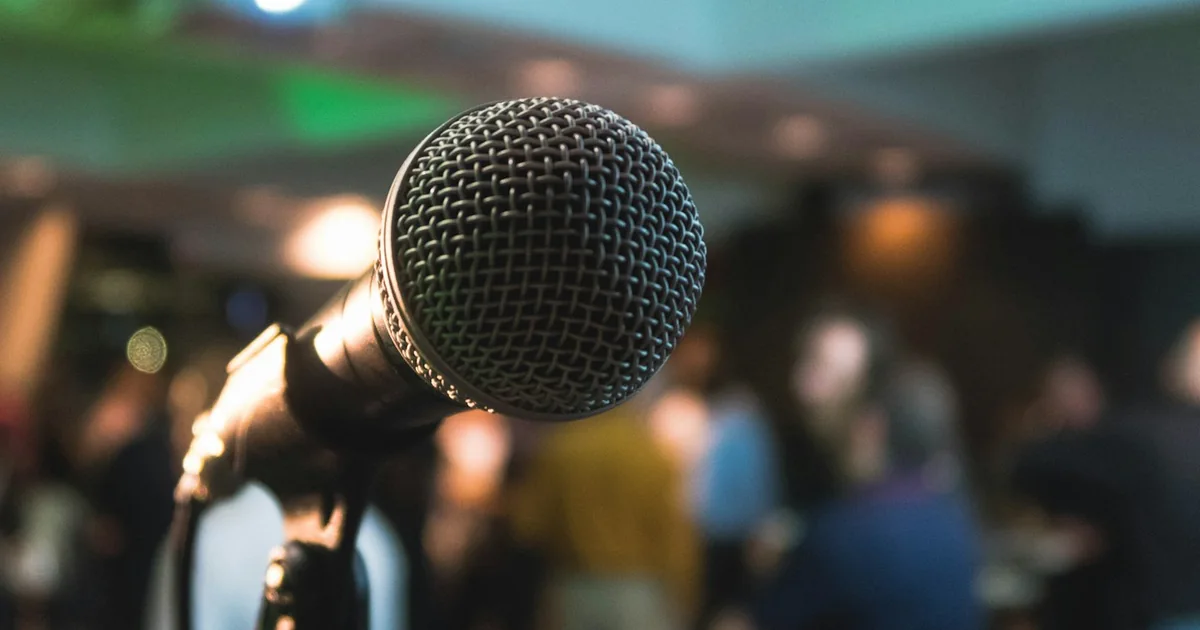 A speaker addressing a professional conference audience